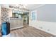 Bright dining area with grey walls, wood floors and decorative trim leading into the kitchen at 5380 Northchester Ct, Dunwoody, GA 30338