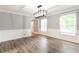 Bright dining room featuring wood floors, wainscoting, and view to hallway at 5380 Northchester Ct, Dunwoody, GA 30338