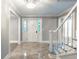 Elegant foyer with crown molding, chandelier lighting, and ceramic tile flooring at 5380 Northchester Ct, Dunwoody, GA 30338