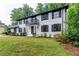 Elegant home with a brick facade, black shutters, and a small balcony above the entrance at 5380 Northchester Ct, Dunwoody, GA 30338