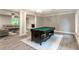 Spacious game room featuring a billiard table and open access to a cozy living area at 5380 Northchester Ct, Dunwoody, GA 30338