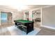 Inviting game room featuring a pool table, decorative lighting, and an open layout at 5380 Northchester Ct, Dunwoody, GA 30338