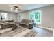 Cozy living room featuring neutral paint, modern ceiling fan, and natural light from large windows at 5380 Northchester Ct, Dunwoody, GA 30338