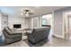 Bright and airy living room features white brick fireplace and access to dining area at 5380 Northchester Ct, Dunwoody, GA 30338
