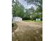 Large backyard featuring a two car detached garage, storage shed, and driveway at 6860 Parkway Dr, Lithonia, GA 30058