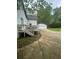 Backyard with a deck and a driveway leading to the detached garage at 6860 Parkway Dr, Lithonia, GA 30058
