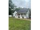 Charming home showcasing a welcoming front porch, red door, and a well-maintained lawn at 6860 Parkway Dr, Lithonia, GA 30058