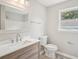 Modern bathroom featuring a wood vanity, white countertop, and updated fixtures at 789 Third St, Stone Mountain, GA 30083