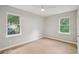 Bedroom featuring wood flooring, a ceiling fan, and two windows with outdoor views at 789 Third St, Stone Mountain, GA 30083