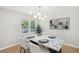 Bright dining room features a modern light fixture, marble table, and large windows at 789 Third St, Stone Mountain, GA 30083