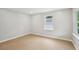 Bright, empty room features new paint, lots of light, and modern hardwood flooring at 789 Third St, Stone Mountain, GA 30083