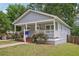 Delightful house with a covered porch, vibrant landscaping, and a well-maintained lawn at 789 Third St, Stone Mountain, GA 30083