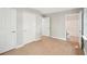 Hallway with wood floors, multiple doors, and access to the bathroom at 789 Third St, Stone Mountain, GA 30083