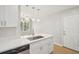 Kitchen featuring quartz countertops, stainless appliances, island with sink, and modern lighting at 789 Third St, Stone Mountain, GA 30083