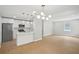 Open kitchen and living room space with modern lighting and stainless steel appliances at 789 Third St, Stone Mountain, GA 30083