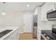 Kitchen featuring quartz countertops, stainless appliances, island with sink, and modern lighting at 789 Third St, Stone Mountain, GA 30083