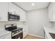 Modern kitchen with white cabinets, stainless steel appliances, and a clean design at 789 Third St, Stone Mountain, GA 30083