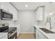 Modern kitchen with white cabinets, stainless steel appliances, and a clean design at 789 Third St, Stone Mountain, GA 30083