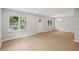Bright living room featuring wood floors, fresh paint, large windows, and modern light fixture at 789 Third St, Stone Mountain, GA 30083