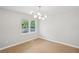 Bright living room featuring wood floors, fresh paint, large windows, and modern light fixture at 789 Third St, Stone Mountain, GA 30083