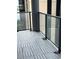 Balcony featuring neutral pavers and glass panels, providing a sleek and modern outdoor space at 1280 W Peachtree Nw St # 2409, Atlanta, GA 30309
