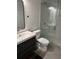 A modern bathroom featuring a sleek vanity, toilet, and glass-enclosed shower at 1280 W Peachtree Nw St # 2409, Atlanta, GA 30309