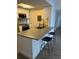 Modern kitchen featuring stainless steel appliances, a kitchen island, and barstool seating at 1280 W Peachtree Nw St # 2409, Atlanta, GA 30309