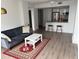 Living room with a gray sofa, white coffee table, and view into the kitchen with modern appliances at 1280 W Peachtree Nw St # 2409, Atlanta, GA 30309