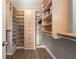 Spacious walk-in closet with custom wood shelving and storage, drawers, and racks at 1280 W Peachtree Nw St # 2409, Atlanta, GA 30309