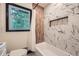 Bathroom with white tub, black trim on windows and wooden style wall at 1722 San Gabriel Ave, Decatur, GA 30032