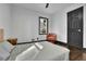 Bright bedroom features hardwood floors, a black door, and a window with a view of the outdoors at 1722 San Gabriel Ave, Decatur, GA 30032