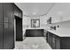 Modern kitchen features a combination of white and dark cabinetry and stainless steel appliances at 1722 San Gabriel Ave, Decatur, GA 30032