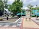 Outdoor courtyard with green murals, lights, sculpture and Decatur city directory at 1722 San Gabriel Ave, Decatur, GA 30032