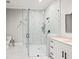Modern bathroom featuring a glass-enclosed shower, marble tile, and a stylish vanity at 481 Saddle Ridge Dr, Lawrenceville, GA 30046