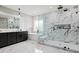 Elegant bathroom featuring a glass shower, soaking tub, marble accents, and double vanity at 481 Saddle Ridge Dr, Lawrenceville, GA 30046