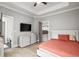 Bedroom featuring a bed, dresser with TV, and two open doorways at 481 Saddle Ridge Dr, Lawrenceville, GA 30046