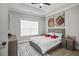Cozy bedroom featuring a queen-sized bed, gray dresser, and a large window at 481 Saddle Ridge Dr, Lawrenceville, GA 30046