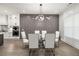 Modern dining room with designer lighting, glass table, and stylish decor for elegant meals at 481 Saddle Ridge Dr, Lawrenceville, GA 30046