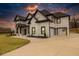 Stunning two-story home boasting modern black and white design and an expansive driveway at 481 Saddle Ridge Dr, Lawrenceville, GA 30046