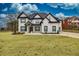Stunning two-story home boasts a modern design with black trim, complemented by a well-manicured lawn at 481 Saddle Ridge Dr, Lawrenceville, GA 30046