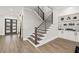 Hallway with wood staircase, modern railing, and a view of the home's entry at 481 Saddle Ridge Dr, Lawrenceville, GA 30046