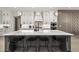 Gourmet kitchen featuring a large island with a waterfall countertop and modern pendant lighting at 481 Saddle Ridge Dr, Lawrenceville, GA 30046