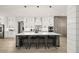 Elegant kitchen featuring a large island, stainless appliances, and herringbone accent wall at 481 Saddle Ridge Dr, Lawrenceville, GA 30046