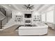 Bright living room with custom built-ins, fireplace, and elegant white sectional sofa at 481 Saddle Ridge Dr, Lawrenceville, GA 30046