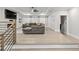 Open-concept living room with a large gray couch, built-in shelves, and wood flooring at 481 Saddle Ridge Dr, Lawrenceville, GA 30046