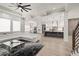 Open-concept living space showcases a modern kitchen, living room, and staircase at 481 Saddle Ridge Dr, Lawrenceville, GA 30046