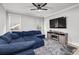 Comfortable living room with a large blue sectional sofa and a modern entertainment center at 481 Saddle Ridge Dr, Lawrenceville, GA 30046