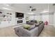 A spacious living room features a large sectional couch, fireplace, and built in shelves at 481 Saddle Ridge Dr, Lawrenceville, GA 30046