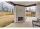 Covered patio features a white brick fireplace and outdoor seating overlooking the spacious backyard at 481 Saddle Ridge Dr, Lawrenceville, GA 30046