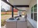 Covered outdoor patio with a fireplace and comfortable seating area, perfect for entertaining at 481 Saddle Ridge Dr, Lawrenceville, GA 30046